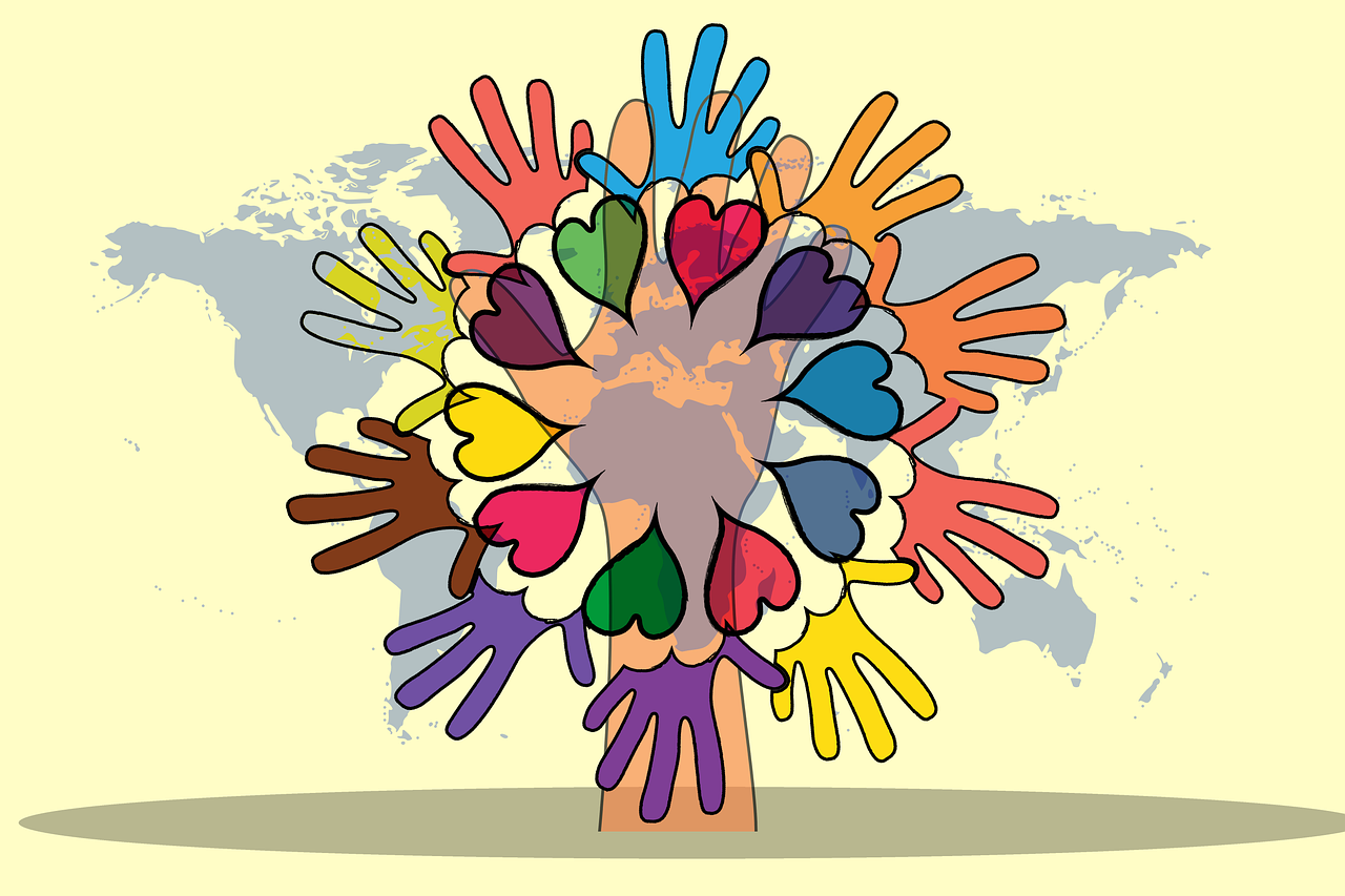 Zahlreiche Hände und Herzen, dahinter Weltkarte - Symbol für Ehrenamt